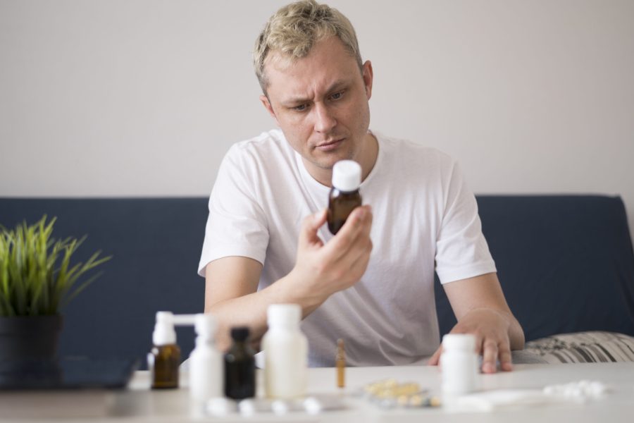 man-reading-from-treatment-glass-container